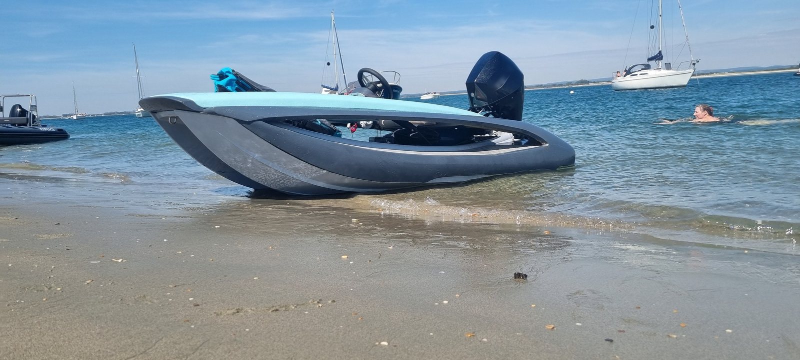 The REALMS SUT Drift 340 on a sandy beach in summer